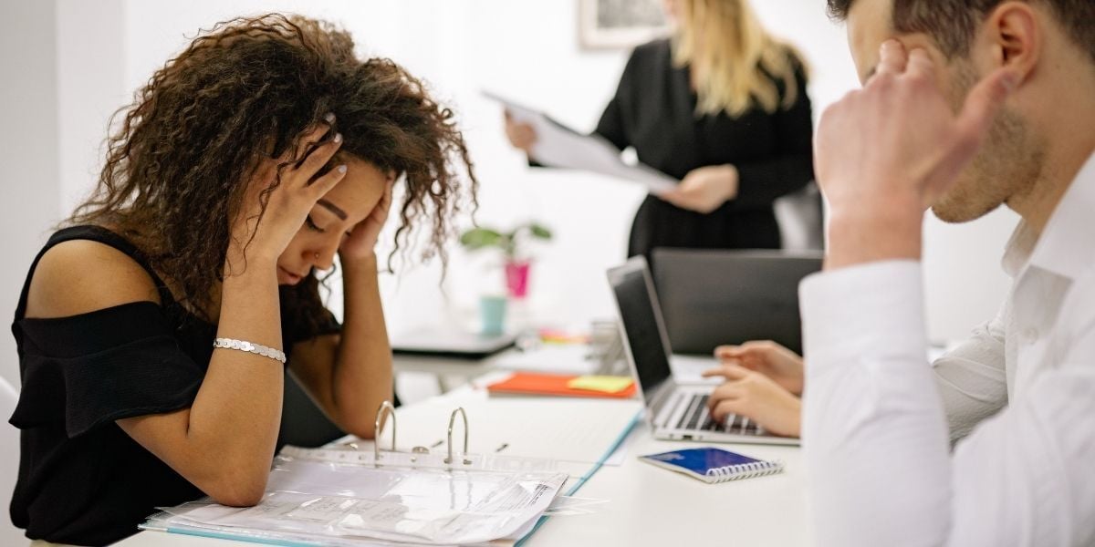 Woman looking stressed and uncomfortable while working in a commercial building