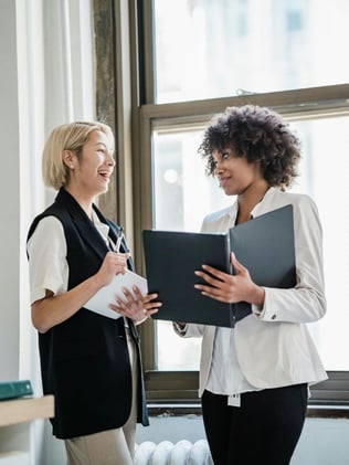 Happy Office Workers representing working in a building with clean air from using preventative maintenance to keep HVAC system clean, which prevents allergens ffrom spreading. 