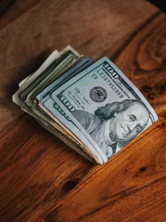 Money symbolizing the savings off your plumbing upgrades