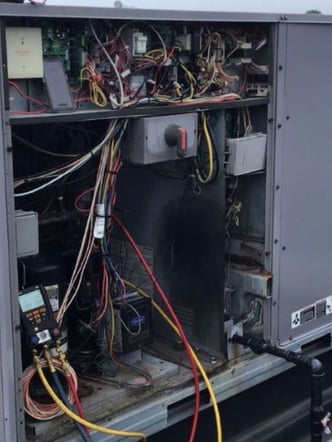 Opened up rooftop HVAC unit for a commercial building during a service visit for preventative maintenance
