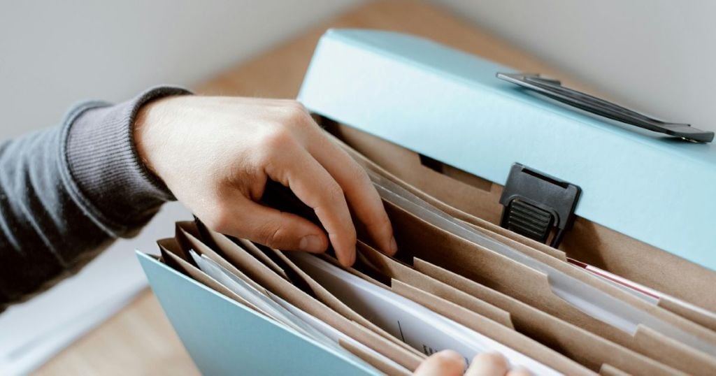 Person looking into a file box with paperwork