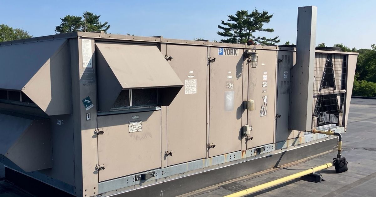 Rooftop packaged HVAC unit (RTU) by York on a commercial building, showing aging equipment that may need retrofit or replacement.
