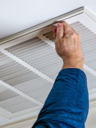 Technician removing vent to diagnose poor ventilation