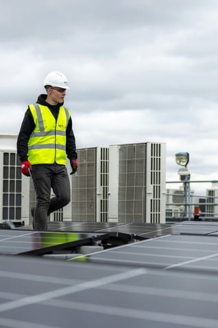 Tech on roof with solar panels