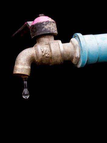 Dripping faucet representing a plumbing leak