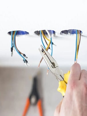 Wires hanging which represents electrical issues that could impact a zoning system or building management system