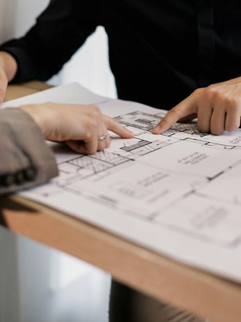 Commercial business owners going over plumbing construction plans 