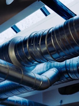 Large HVAC ductwork in a commercial building that represents potential sizing issues with an HVAC system