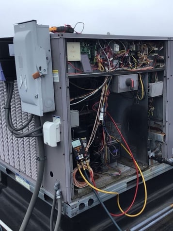 Opened up commercial HVAC rooftop unit that is prone to short cycling.
