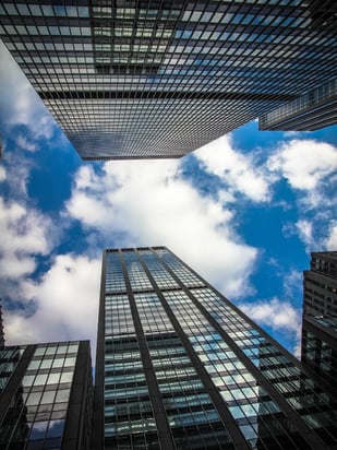 Low view of large commercial buildings that represent spaces that may not heat and cool evenly