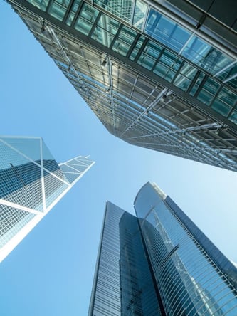 Looking up at large commercial buildings that represent different building sizes