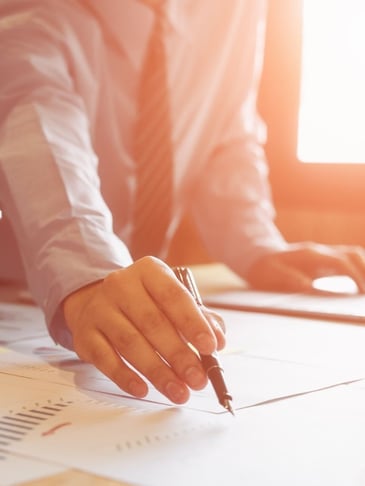 Commercial building facility manager comparing HVAC service quotes from multiple companies