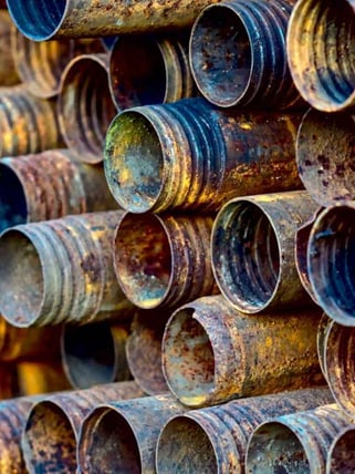 Corroded plumbing pipes stacked on top of eachother