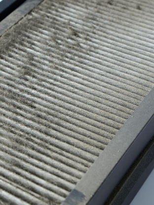 Dirty air filter representing an HVAC unit that needs to be cleaned in springtime
