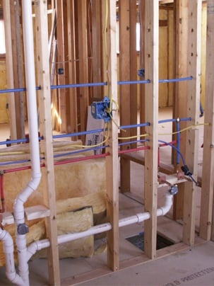Inside the walls of a commercial building, showing some of the internal plumbing system.