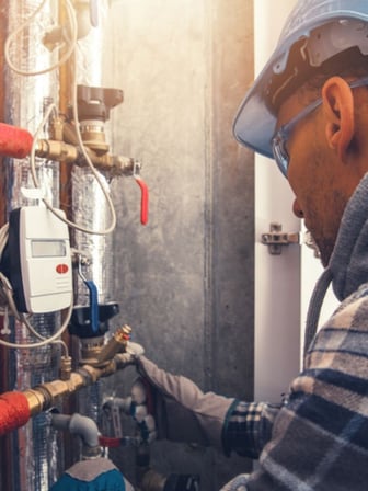 HVAC tech looking over a buildings HVAC system