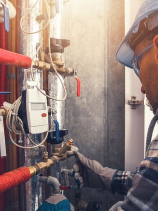 HVAC service technician working on a commercial building during a maintenance call