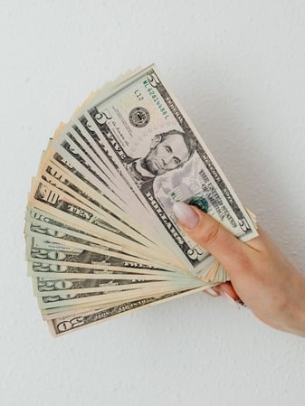 Money fan representing the amount of money saved by investing in a preventative maintenance contract