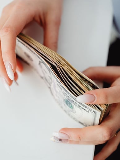 Money stack representing the money you can save by taking care of a commercial building plumbing system