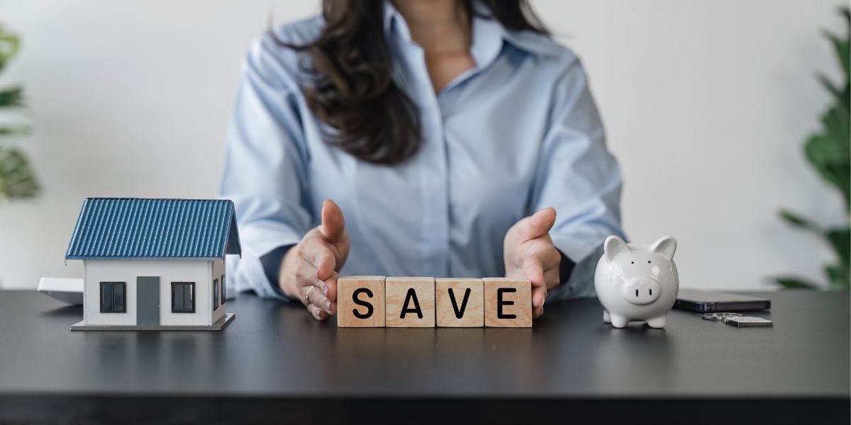 a woman with tiles spelling out SAVE in front of her