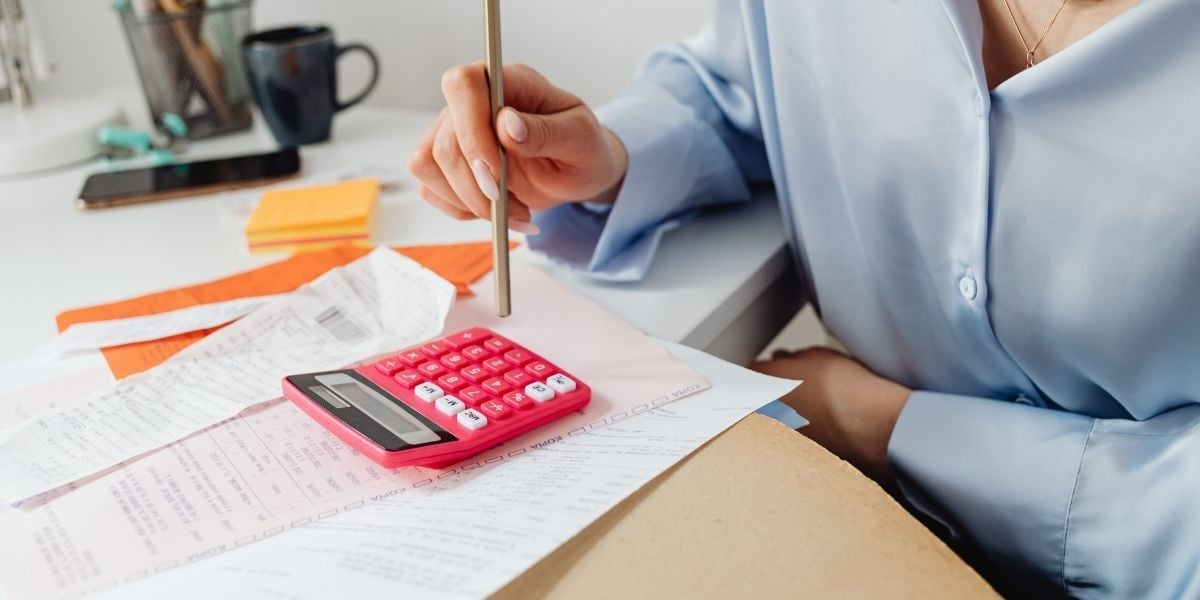 An office manager calculating the costs of the soaring energy bills in Quincy MA in 2025