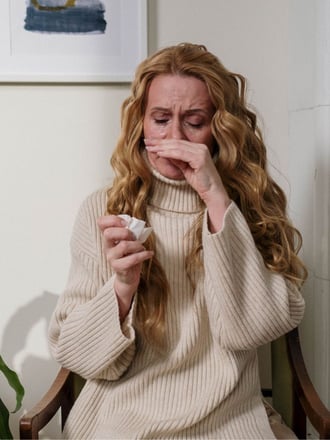 Woman with Allergies caused by dirty air filters and allergens being spread by a commercial buildings HVAC system