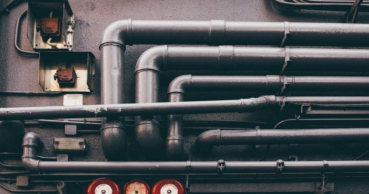 a section of industrial or commercial piping mounted on a wall.